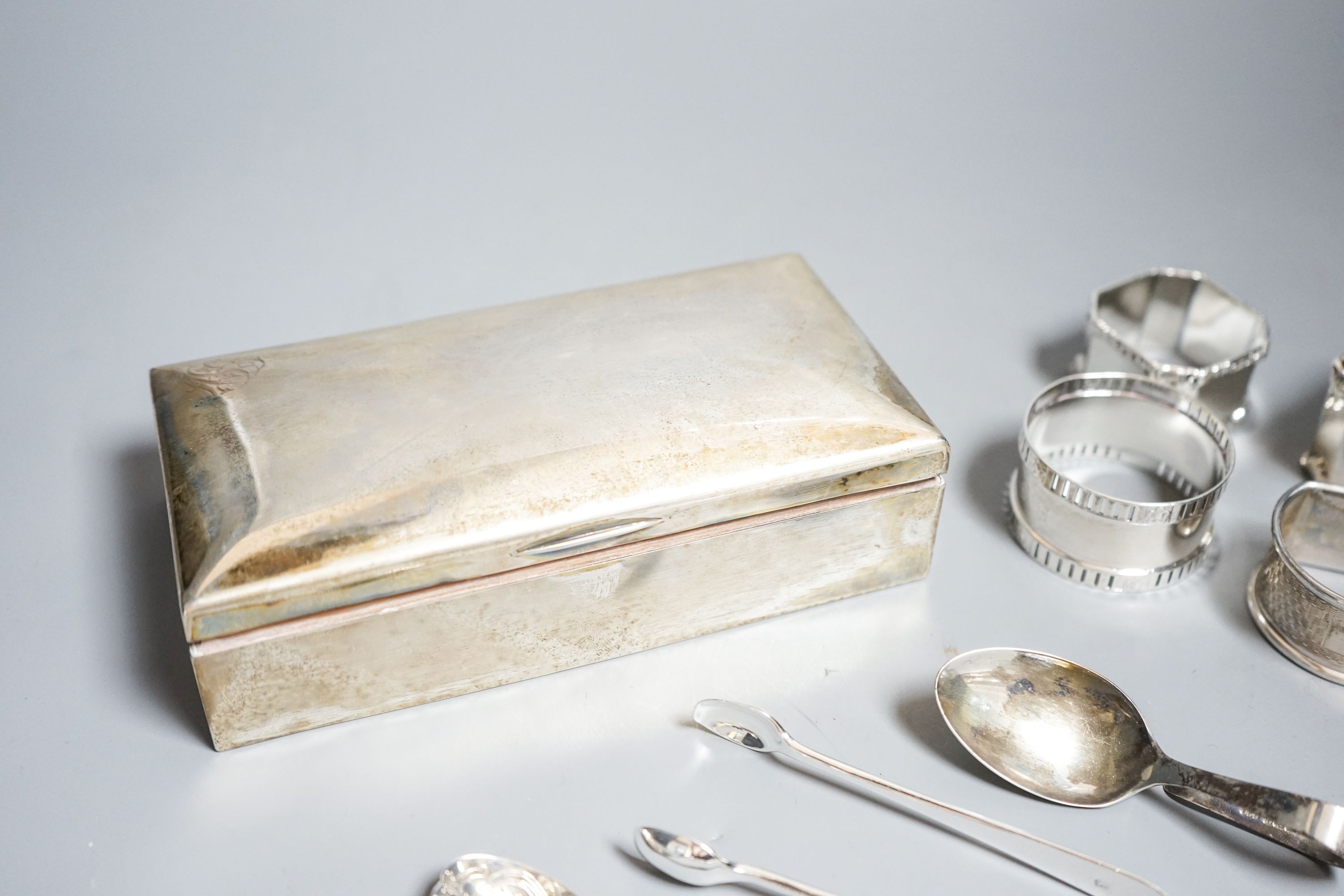 Small silver including a German 800 mounted cigarette box, five napkin rings, spoons etc.